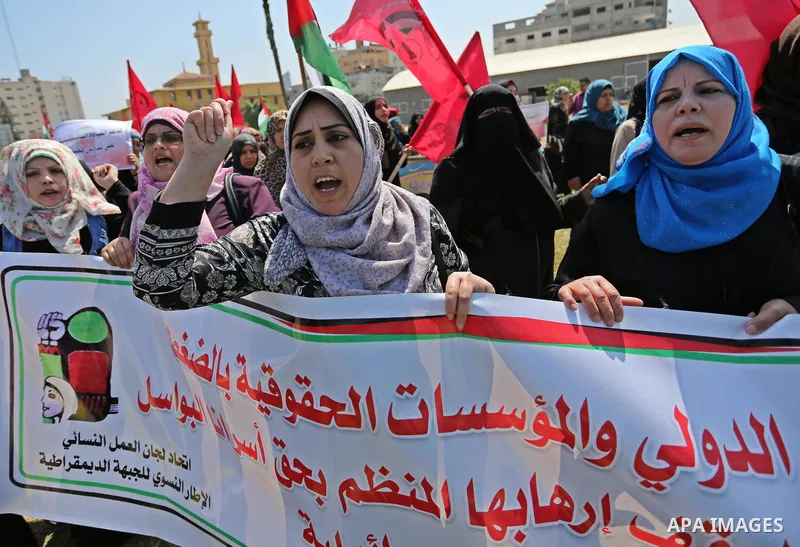 Palestinian supporters of the Democratic Front for the Liberation of Palestine (DFLP), hold banners during a protest to show solidarity with Palestinian prisoners on hunger strike in Israeli jails, in Gaza city on April...