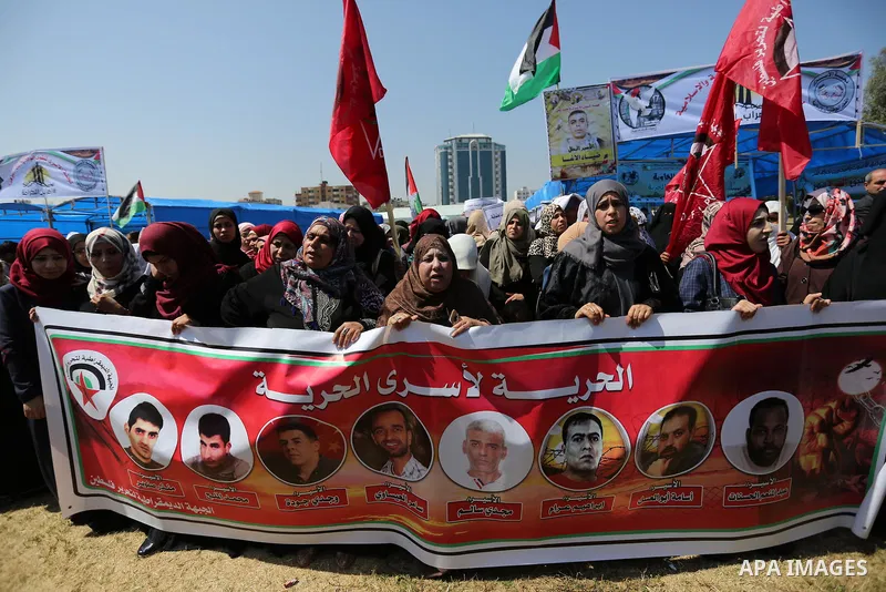 Palestinian supporters of the Democratic Front for the Liberation of Palestine (DFLP), hold banners during a protest to show solidarity with Palestinian prisoners on hunger strike in Israeli jails, in Gaza city on April...
