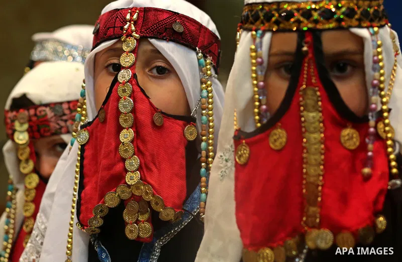 Palestinian girls wear heritage as they pose for a photograph during a ceremony, in Gaza City April 20, 2017. Photo by Ashraf Amra