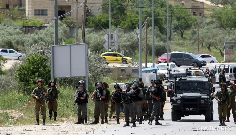 Israeli soldiers take position during a demonstration following Friday prayers in solidarity with Palestinian prisoners on hunger strike in Israeli jails, in the West Bank village of Beita, southeast of Nablus city on Ap...