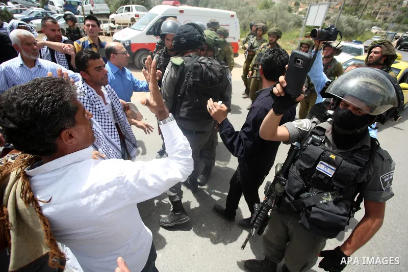 Israeli soldiers clash with Plestinian protesters during a demonstration following Friday prayers in solidarity with Palestinian prisoners on hunger strike in Israeli jails, in the West Bank village of Beita, southeast o...