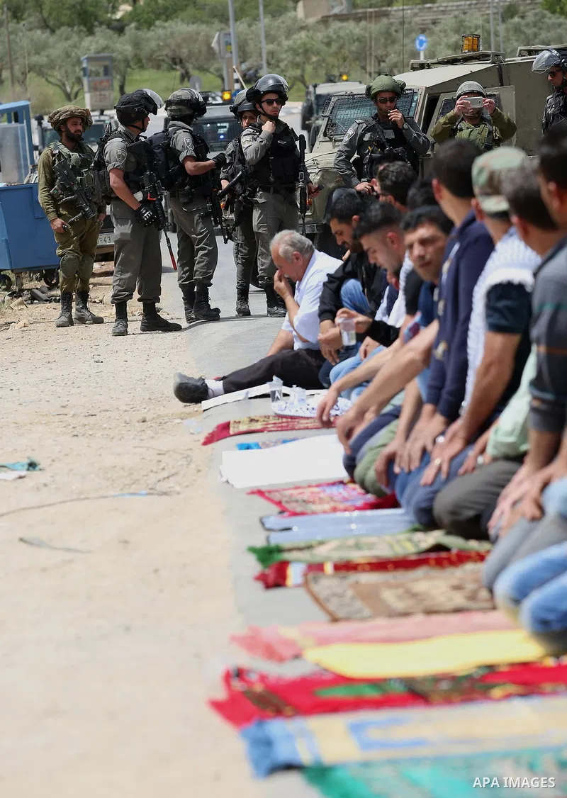 Palestinians demonstrators preform Friday prayers in the West Bank village of Beita, southeast of Nablus city, prior to a demonstration in solidarity with Palestinian prisoners on hunger strike in Israeli jails, on April...