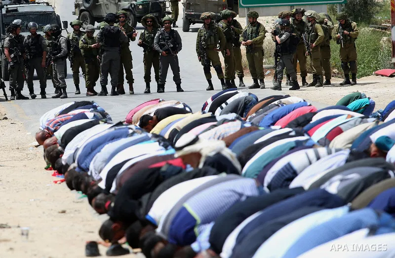 Palestinians demonstrators preform Friday prayers in the West Bank village of Beita, southeast of Nablus city, prior to a demonstration in solidarity with Palestinian prisoners on hunger strike in Israeli jails, on April...