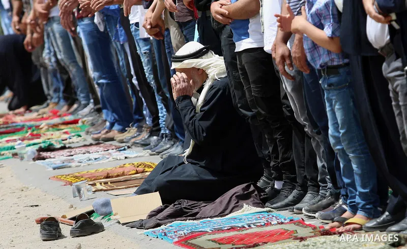 Palestinians demonstrators preform Friday prayers in the West Bank village of Beita, southeast of Nablus city, prior to a demonstration in solidarity with Palestinian prisoners on hunger strike in Israeli jails, on April...