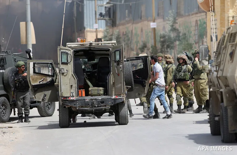 Israeli soldiers arrest Palestinian demonstrators amid clashes in the West Bank village of Beita, southeast of Nablus city on April 21, 2017. Some 1,500 Palestinian prisoners have joined the hunger strike that began earl...