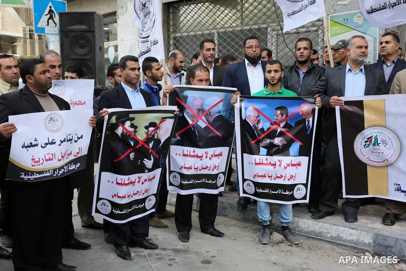 Palestinian supporters of Al-Ahrar movement hold banners during a protest against Palestinian President Mahmoud Abbas and Israeli blockade of the Gaza Strip, in Gaza city, on April 22, 2017. Photo by Ashraf Amra