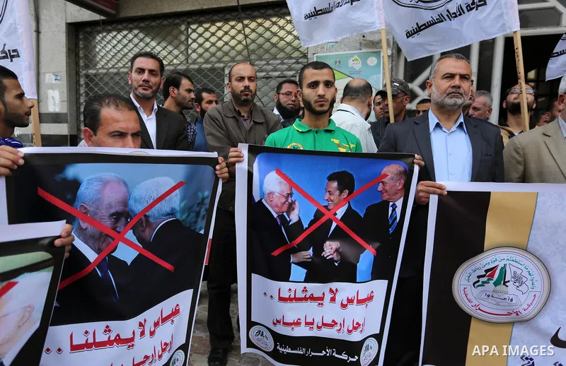 Palestinian supporters of Al-Ahrar movement hold banners during a protest against Palestinian President Mahmoud Abbas and Israeli blockade of the Gaza Strip, in Gaza city, on April 22, 2017. Photo by Ashraf Amra
