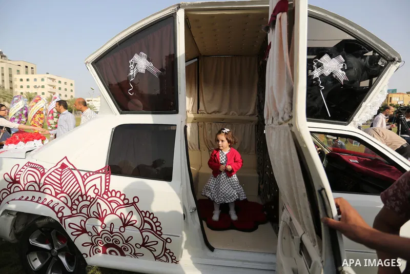 Palestinians look "Cinderella" vehicle in Gaza City on April 22, 2017. Made up of five different cars, it will be rented out for use at marriage ceremonies. Photo by Ashraf Amra