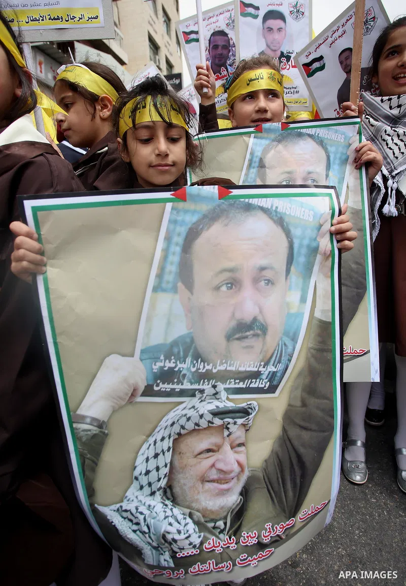 Palestinian protesters hold banners during a demonstration in solidarity with Palestinian prisoners on hunger strike in Israeli jails, in the West Bank of Nablus on April 23, 2017. Some 1,500 Palestinian prisoners have j...