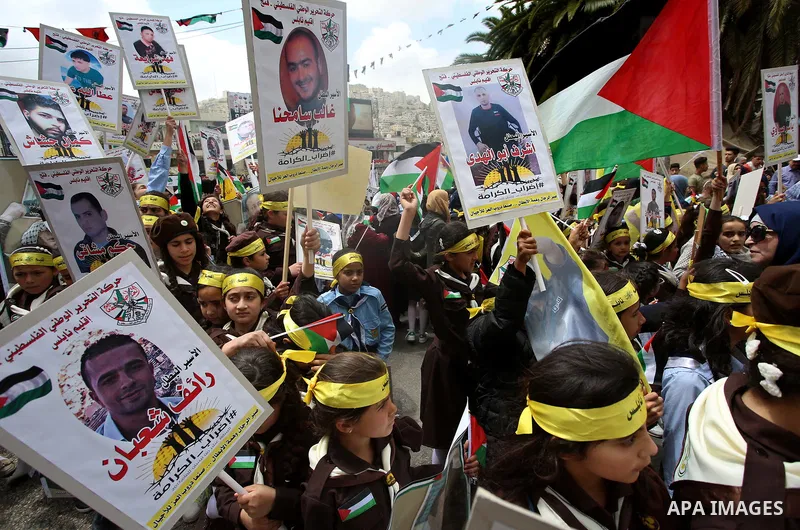 Palestinian protesters hold banners during a demonstration in solidarity with Palestinian prisoners on hunger strike in Israeli jails, in the West Bank of Nablus on April 23, 2017. Some 1,500 Palestinian prisoners have j...