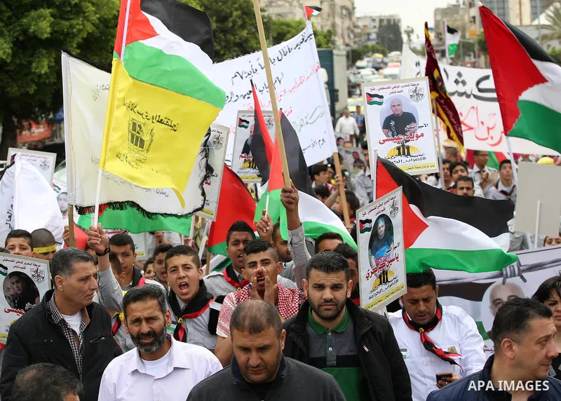 Palestinian protesters hold banners during a demonstration in solidarity with Palestinian prisoners on hunger strike in Israeli jails, in the West Bank of Nablus on April 23, 2017. Some 1,500 Palestinian prisoners have j...