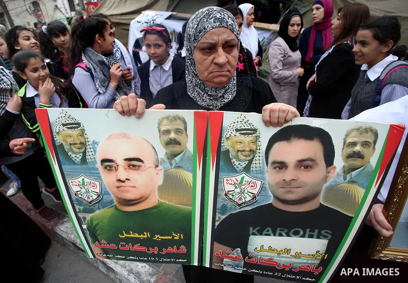 Palestinian protesters hold banners during a demonstration in solidarity with Palestinian prisoners on hunger strike in Israeli jails, in the West Bank of Nablus on April 23, 2017. Some 1,500 Palestinian prisoners have j...