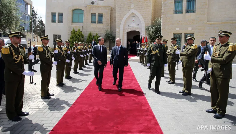 Palestinian Prime Minister Rami Hamdallah and Austria's Chancellor Christian Kern review the honor guard during a welcome ceremony in the West Bank city of Ramallah, on April 23, 2017. Photo by Prime Minister Office