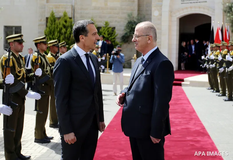 Palestinian Prime Minister Rami Hamdallah and Austria's Chancellor Christian Kern review the honor guard during a welcome ceremony in the West Bank city of Ramallah, on April 23, 2017. Photo by Prime Minister Office