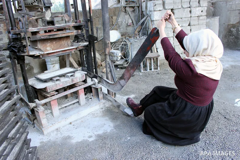 Majd Al Mashharawi, a Palestinian woman produce cement blocks and stones from the remains of houses destroyed by Israeli shelling during the 50-day Israeli war in the summer of 2014 in Gaza city on Feb. 11, 2017. Al Mash...
