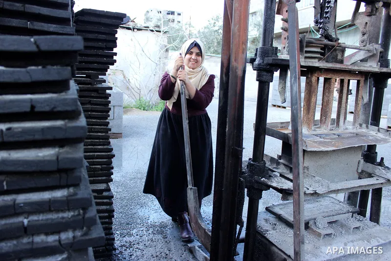 Majd Al Mashharawi, a Palestinian woman produce cement blocks and stones from the remains of houses destroyed by Israeli shelling during the 50-day Israeli war in the summer of 2014 in Gaza city on Feb. 11, 2017. Al Mash...
