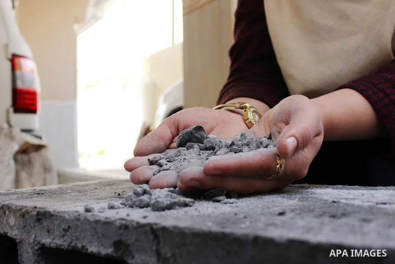 Majd Al Mashharawi, a Palestinian woman produce cement blocks and stones from the remains of houses destroyed by Israeli shelling during the 50-day Israeli war in the summer of 2014 in Gaza city on Feb. 11, 2017. Al Mash...