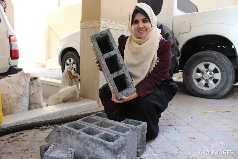 Majd Al Mashharawi, a Palestinian woman produce cement blocks and stones from the remains of houses destroyed by Israeli shelling during the 50-day Israeli war in the summer of 2014 in Gaza city on Feb. 11, 2017. Al Mash...