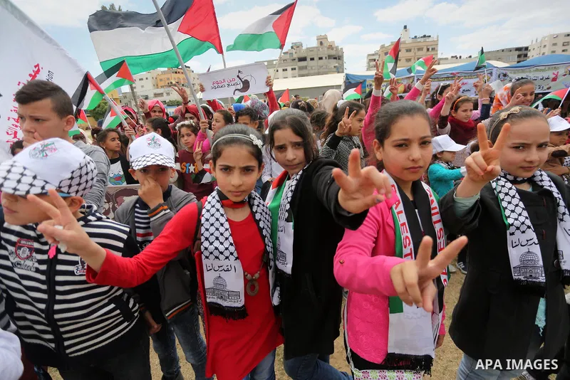 Palestinian protesters hold banners during a protest in solidarity with Palestinian prisoners on hunger strike in Israeli jails, in Gaza city on April 24, 2017. Some 1,500 Palestinian prisoners have joined the hunger str...