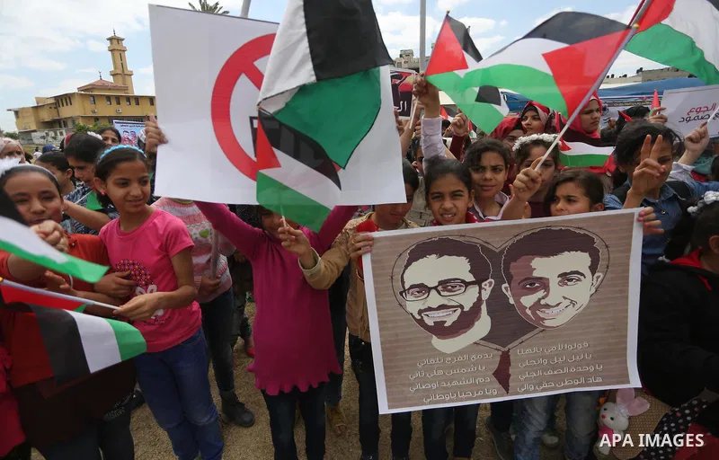 Palestinian protesters hold banners during a protest in solidarity with Palestinian prisoners on hunger strike in Israeli jails, in Gaza city on April 24, 2017. Some 1,500 Palestinian prisoners have joined the hunger str...