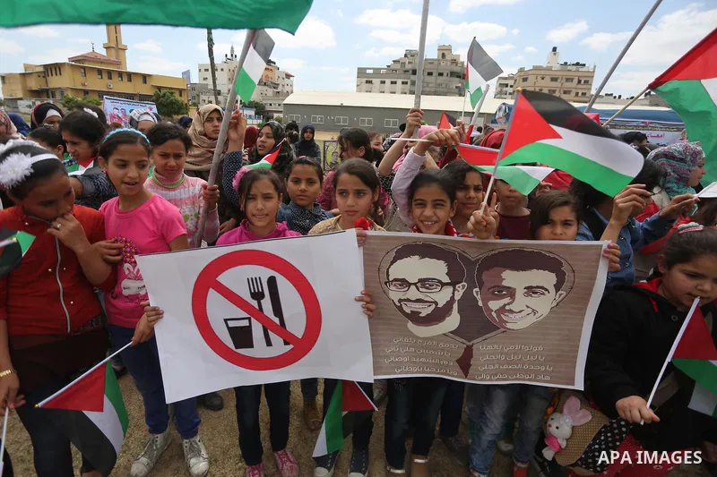 Palestinian protesters hold banners during a protest in solidarity with Palestinian prisoners on hunger strike in Israeli jails, in Gaza city on April 24, 2017. Some 1,500 Palestinian prisoners have joined the hunger str...
