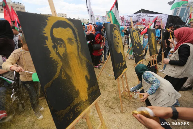 Palestinian protesters hold banners during a protest in solidarity with Palestinian prisoners on hunger strike in Israeli jails, in Gaza city on April 24, 2017. Some 1,500 Palestinian prisoners have joined the hunger str...