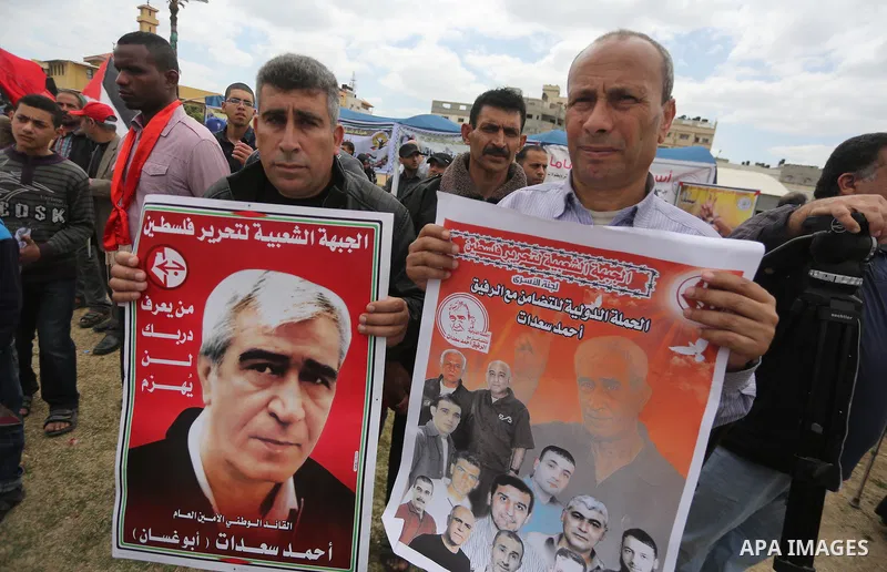 Palestinian protesters hold banners during a protest in solidarity with Palestinian prisoners on hunger strike in Israeli jails, in Gaza city on April 24, 2017. Some 1,500 Palestinian prisoners have joined the hunger str...