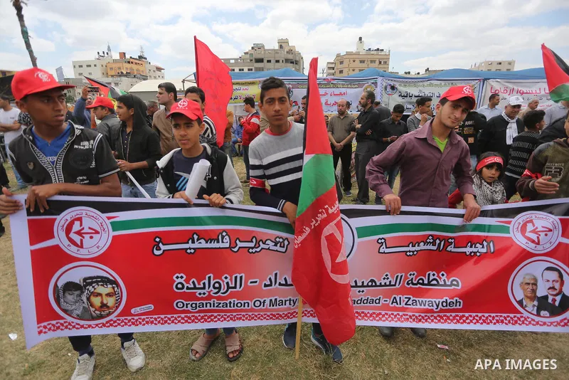 Palestinian protesters hold banners during a protest in solidarity with Palestinian prisoners on hunger strike in Israeli jails, in Gaza city on April 24, 2017. Some 1,500 Palestinian prisoners have joined the hunger str...