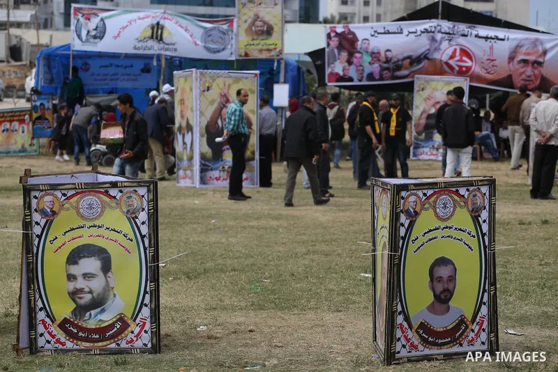 Palestinian protesters hold banners during a protest in solidarity with Palestinian prisoners on hunger strike in Israeli jails, in Gaza city on April 24, 2017. Some 1,500 Palestinian prisoners have joined the hunger str...
