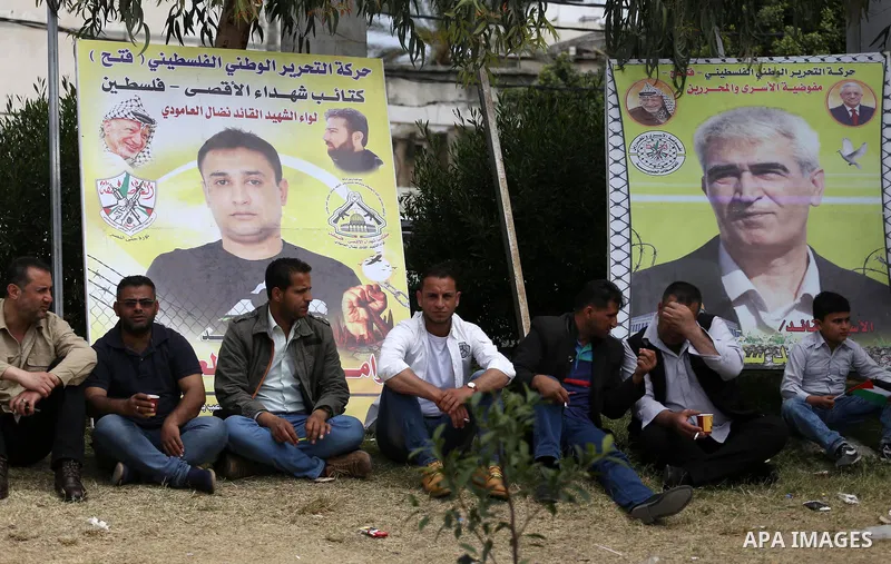 Palestinian protesters hold banners during a protest in solidarity with Palestinian prisoners on hunger strike in Israeli jails, in Gaza city on April 24, 2017. Some 1,500 Palestinian prisoners have joined the hunger str...