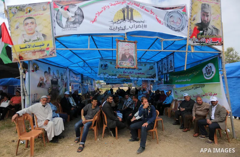 Palestinian protesters hold banners during a protest in solidarity with Palestinian prisoners on hunger strike in Israeli jails, in Gaza city on April 24, 2017. Some 1,500 Palestinian prisoners have joined the hunger str...