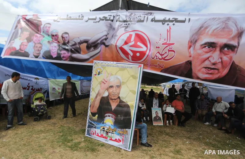 Palestinian protesters hold banners during a protest in solidarity with Palestinian prisoners on hunger strike in Israeli jails, in Gaza city on April 24, 2017. Some 1,500 Palestinian prisoners have joined the hunger str...