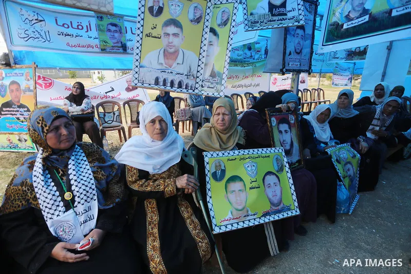 Palestinian protesters hold banners during a protest in solidarity with Palestinian prisoners on hunger strike in Israeli jails, in Gaza city on April 24, 2017. Some 1,500 Palestinian prisoners have joined the hunger str...