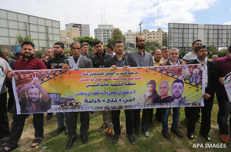 Palestinian protesters hold banners during a protest in solidarity with Palestinian prisoners on hunger strike in Israeli jails, in Gaza city on April 24, 2017. Some 1,500 Palestinian prisoners have joined the hunger str...