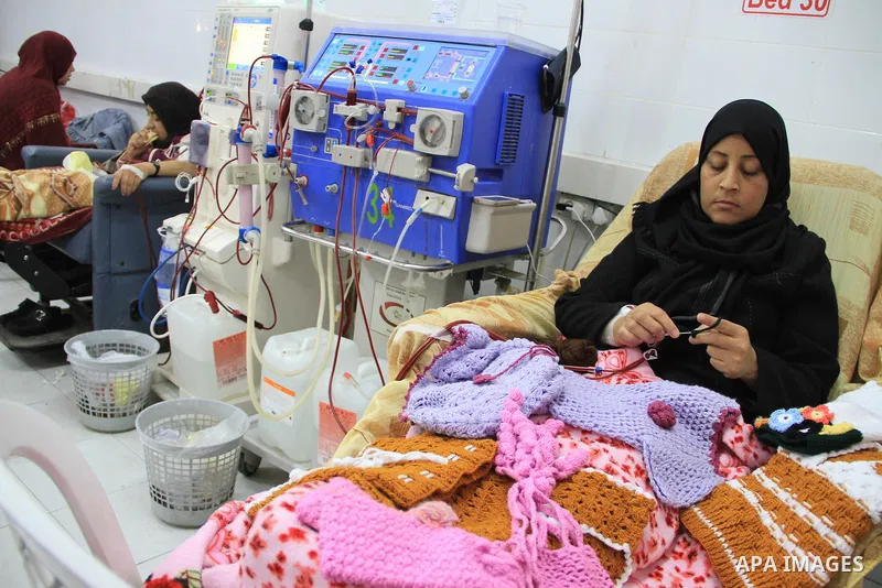Seham al-Helow, 40, a Palestinian patient woman gets her kidneys washed at the dialysis department in the Al-Shifa hospital as she makes crochet dresses in Gaza City on Feb. 14, 2017. al-Helow is one of the women who mas...