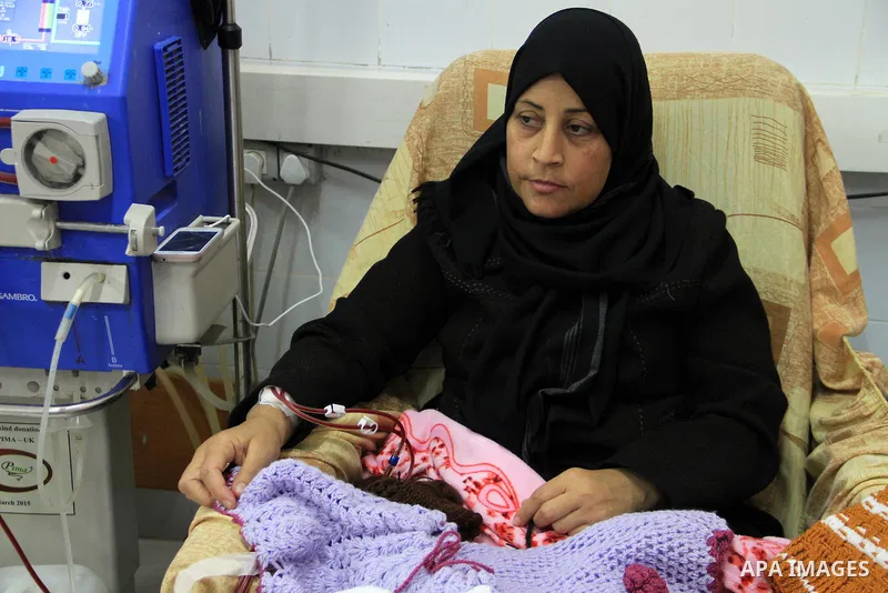 Seham al-Helow, 40, a Palestinian patient woman gets her kidneys washed at the dialysis department in the Al-Shifa hospital as she makes crochet dresses in Gaza City on Feb. 14, 2017. al-Helow is one of the women who mas...