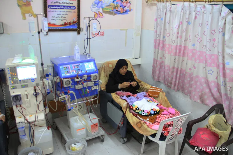Seham al-Helow, 40, a Palestinian patient woman gets her kidneys washed at the dialysis department in the Al-Shifa hospital as she makes crochet dresses in Gaza City on Feb. 14, 2017. al-Helow is one of the women who mas...