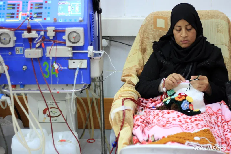 Seham al-Helow, 40, a Palestinian patient woman gets her kidneys washed at the dialysis department in the Al-Shifa hospital as she makes crochet dresses in Gaza City on Feb. 14, 2017. al-Helow is one of the women who mas...