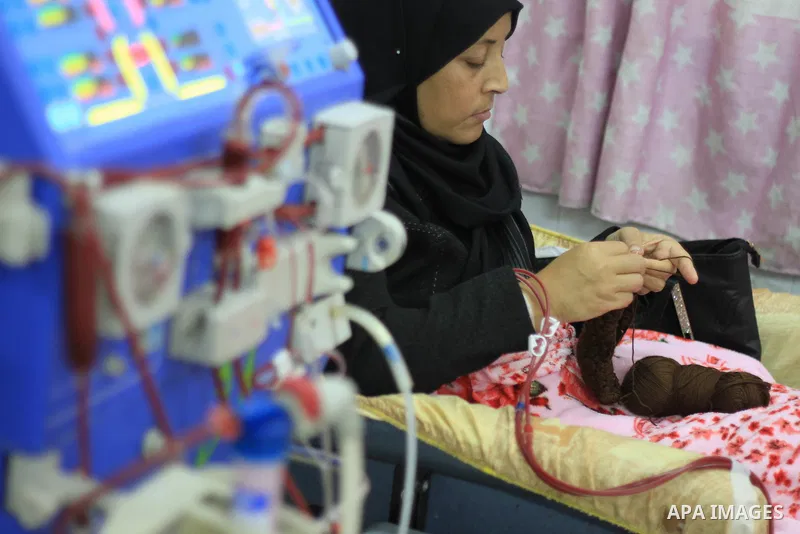 Seham al-Helow, 40, a Palestinian patient woman gets her kidneys washed at the dialysis department in the Al-Shifa hospital as she makes crochet dresses in Gaza City on Feb. 14, 2017. al-Helow is one of the women who mas...