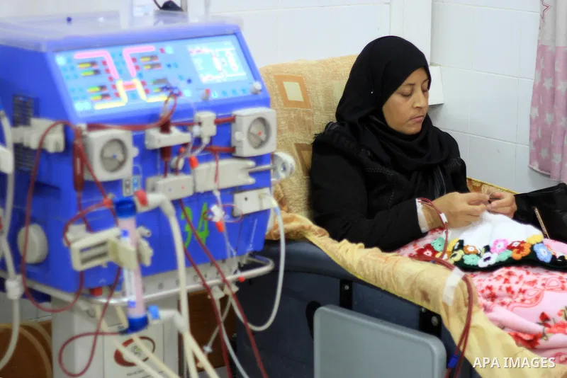Seham al-Helow, 40, a Palestinian patient woman gets her kidneys washed at the dialysis department in the Al-Shifa hospital as she makes crochet dresses in Gaza City on Feb. 14, 2017. al-Helow is one of the women who mas...