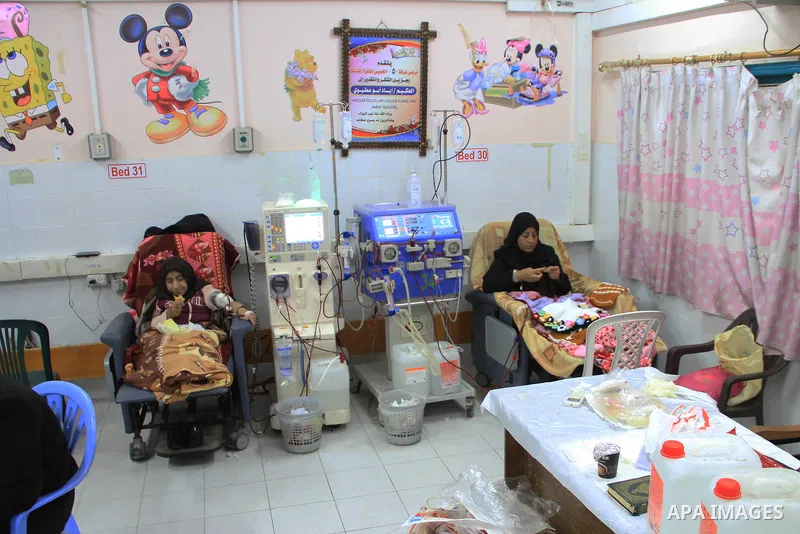 Seham al-Helow, 40, a Palestinian patient woman gets her kidneys washed at the dialysis department in the Al-Shifa hospital as she makes crochet dresses in Gaza City on Feb. 14, 2017. al-Helow is one of the women who mas...