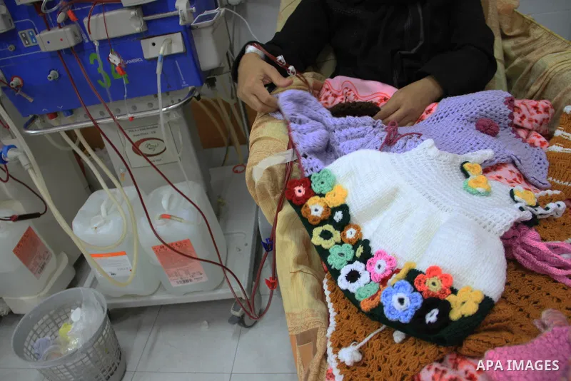 Seham al-Helow, 40, a Palestinian patient woman gets her kidneys washed at the dialysis department in the Al-Shifa hospital as she makes crochet dresses in Gaza City on Feb. 14, 2017. al-Helow is one of the women who mas...