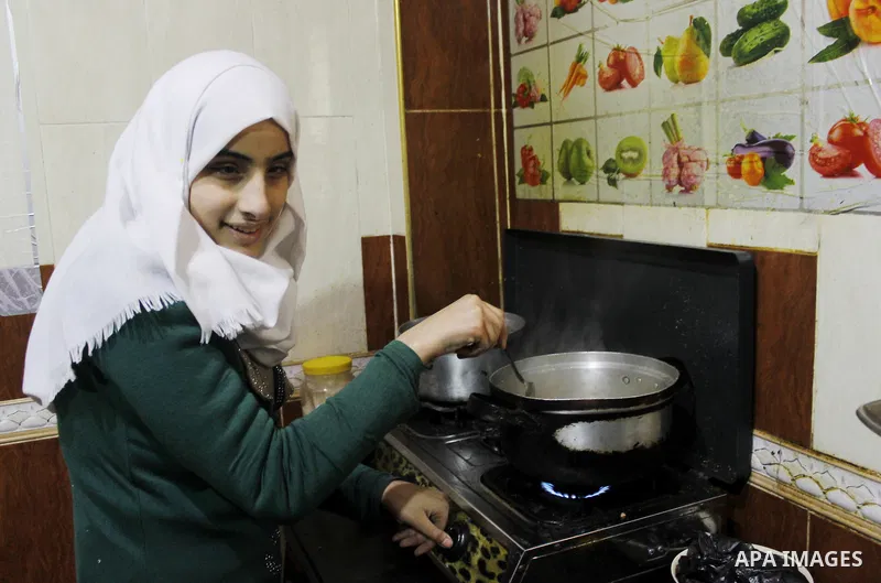 Asmaa Abu Hilal,18, a Palestinian blind student cooks at her family house in Rafah in the southern Gaza strip on Feb. 14, 2017. Abu Hilal superior at her study although there are no private schools for the blind in the c...