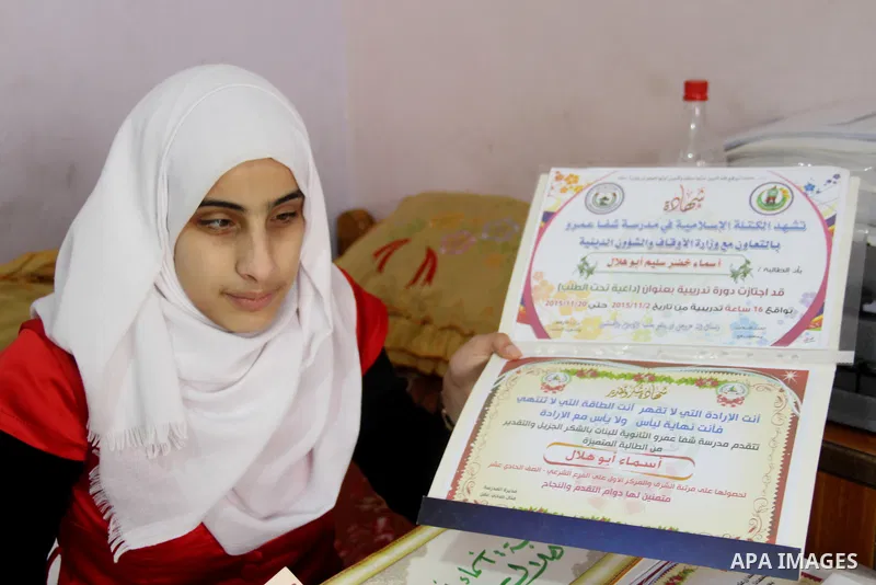 Asmaa Abu Hilal,18, a Palestinian blind studen displays certificates at her family house in Rafah in the southern Gaza strip on Feb. 14, 2017. Abu Hilal superior at her study although there are no private schools for the...
