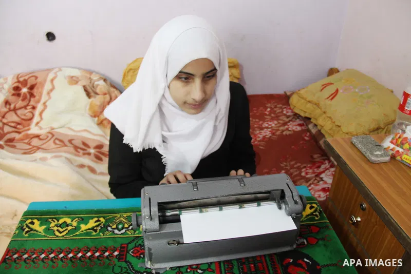 Asmaa Abu Hilal,18, a Palestinian blind studen writes on Braille machine at her family house in Rafah in the southern Gaza strip on Feb. 14, 2017. Abu Hilal superior at her study although there are no private schools for...