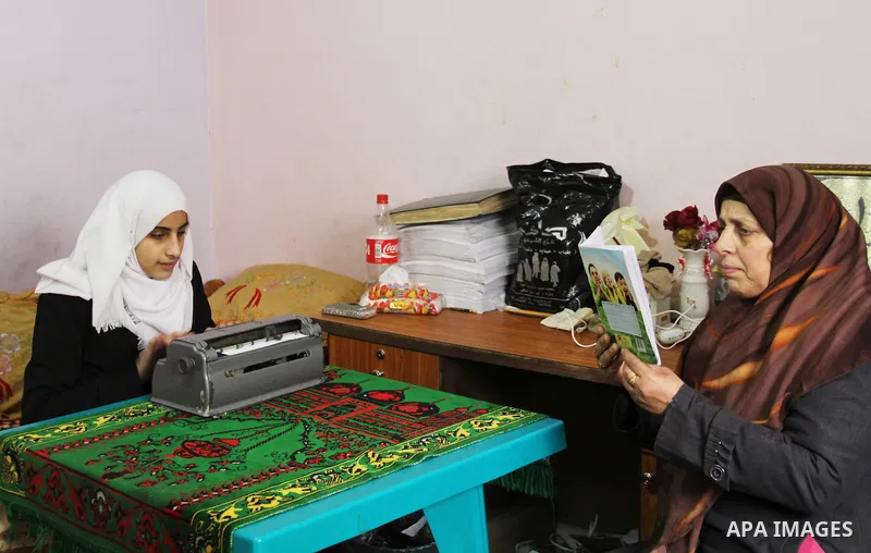 Asmaa Abu Hilal,18, a Palestinian blind studen writes on Braille machine at her family house in Rafah in the southern Gaza strip on Feb. 14, 2017. Abu Hilal superior at her study although there are no private schools for...