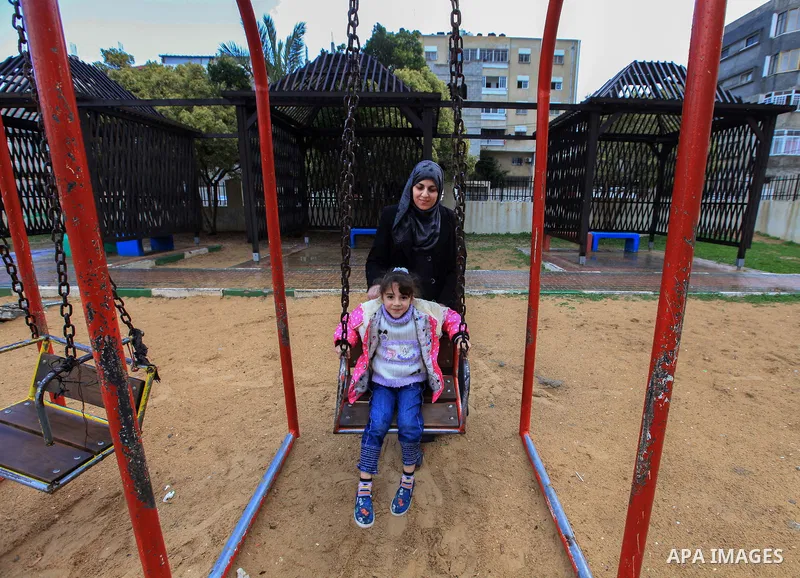 Aisha al-Baroud, 44, a Palestinian woman with breast cancer plays with her daughter in the northern Gaza stirp on Feb. 13, 2017. al-Baroud with breast cancer for more three years makes artificial breasts for mastectomy s...