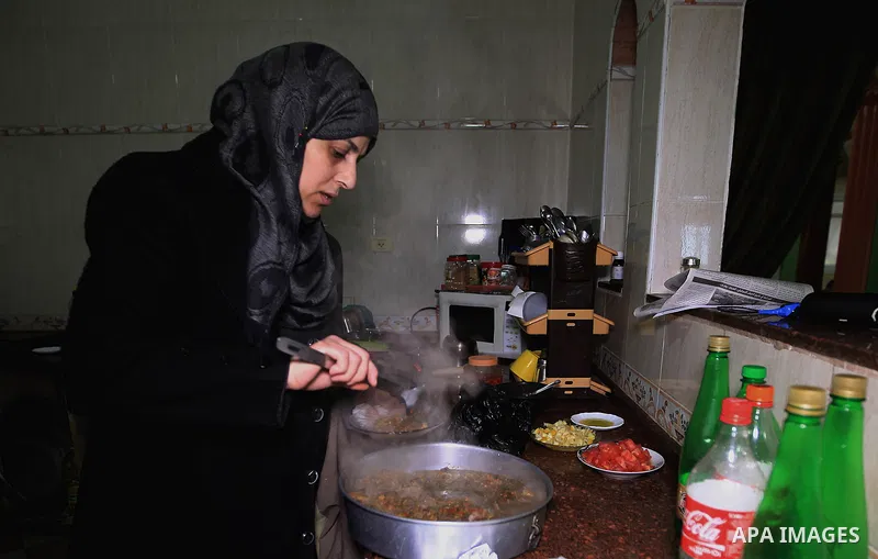 Aisha al-Baroud, 44, a Palestinian woman with breast cancer cooks at her house in the northern Gaza stirp on Feb. 13, 2017. al-Baroud with breast cancer for more three years makes artificial breasts for mastectomy surviv...