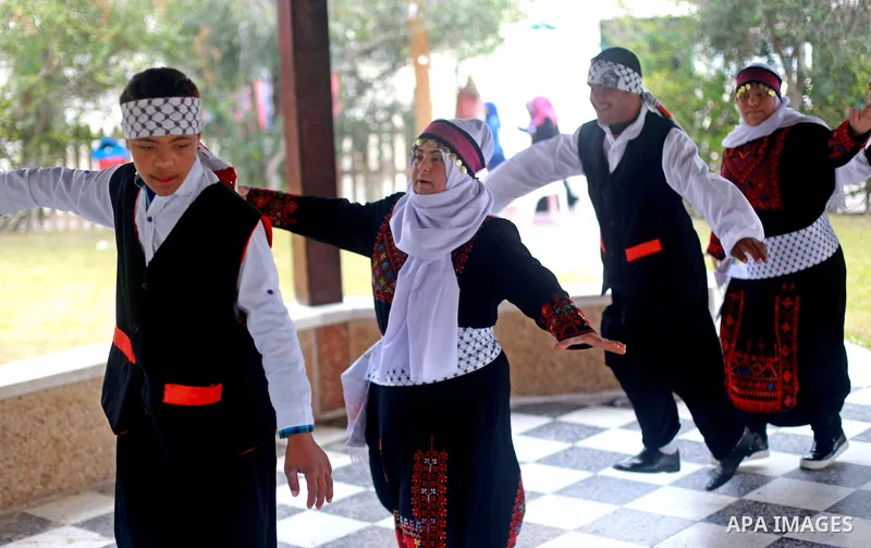 Iman al-Tanani, a 28-year-old a Palestinian woman with Down syndrome wears a traditional dress, as she dances dabka in Gaza city on Feb. 16, 2017. al-Tanani got work from United Nations Relief and Works Agency (UNRWA) on...