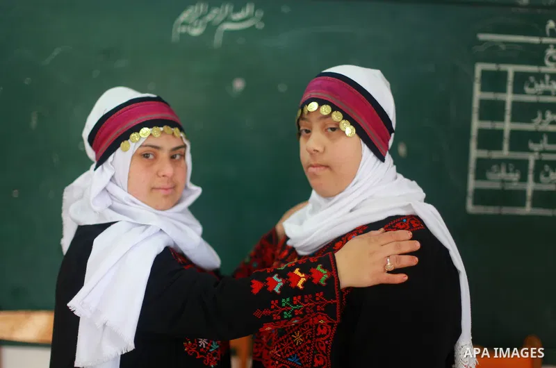 Iman al-Tanani, a 28-year-old a Palestinian woman with Down syndrome wears a traditional dress, as she dances dabka in Gaza city on Feb. 16, 2017. al-Tanani got work from United Nations Relief and Works Agency (UNRWA) on...